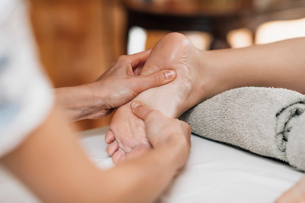 Plush linen, fresh rolled towels, and fragrant botanical petals prepared for luxury treatments